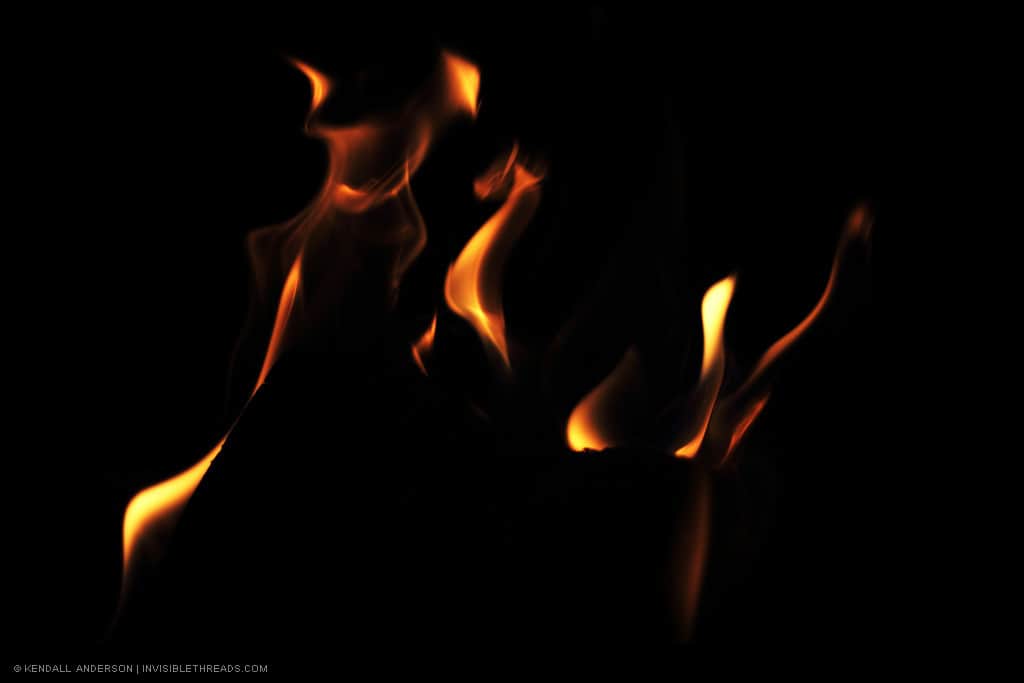 An abstract capture of orange and red flames against a black background.