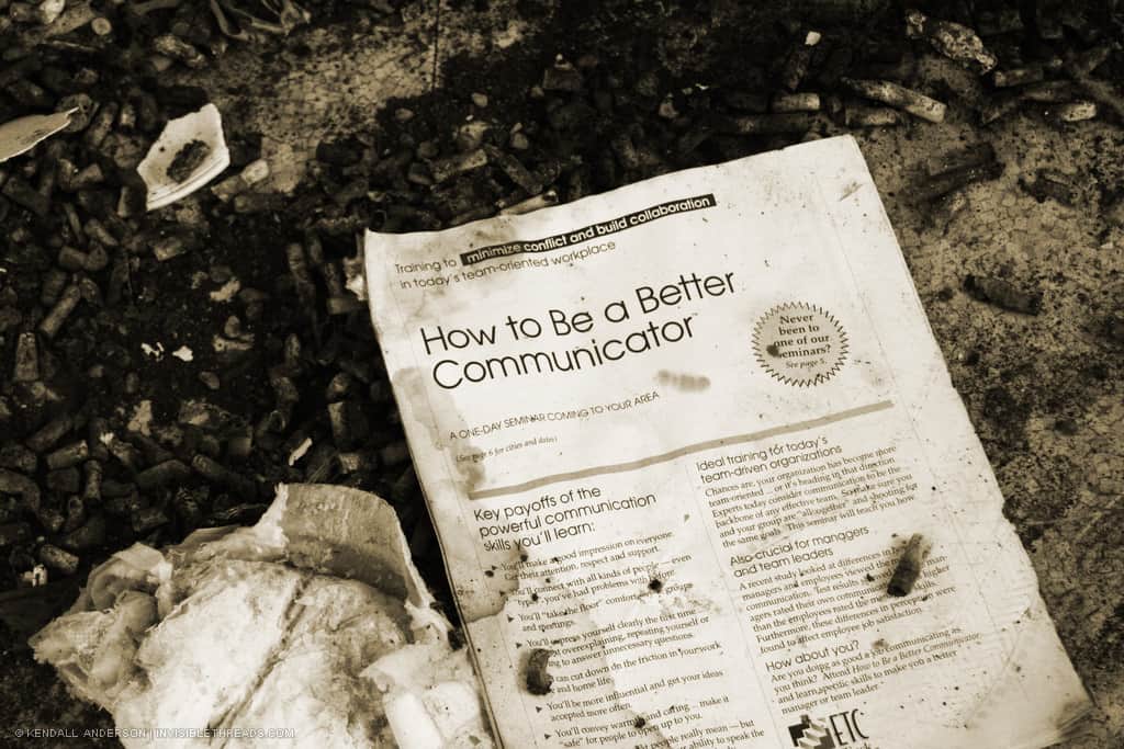 A discarded pamphlet lies on the floor, titled 'How to be a better communicator'.
