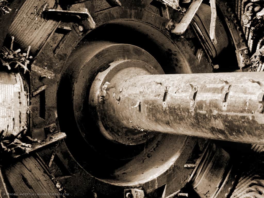 A large metal shaft is connected to an electric motor.