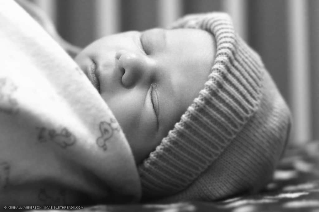 Portrait of sleeping baby wearing knitted cap