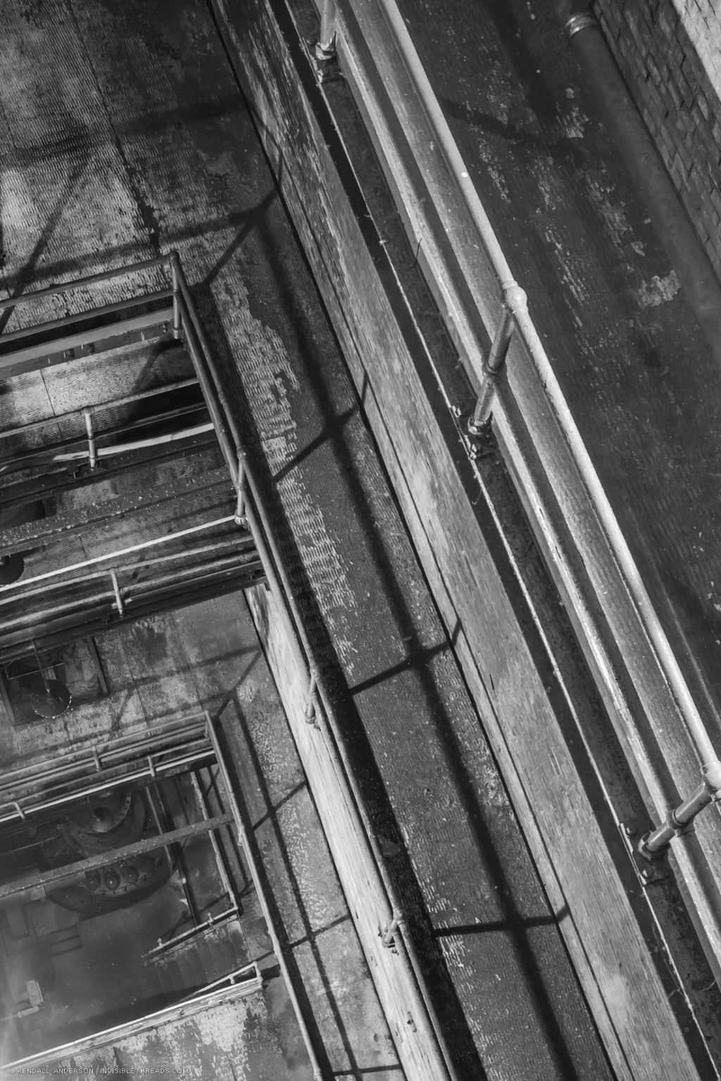 We are looking down at multiple levels of walkways, balconies and handrails leading down to the bottom of power station. These are the areas that provide access to the wheelpit, penstocks and turbines below ground.