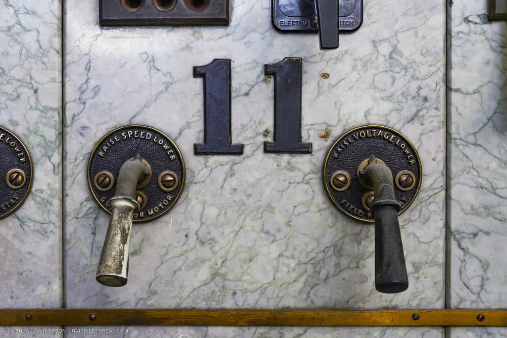 Two handles are mounted on a marble panel below a large number '11'. The handle on the left is labelled 'Raise/Lower Speed' and the handle on the right is labelled 'Raise/Lower Voltage'.